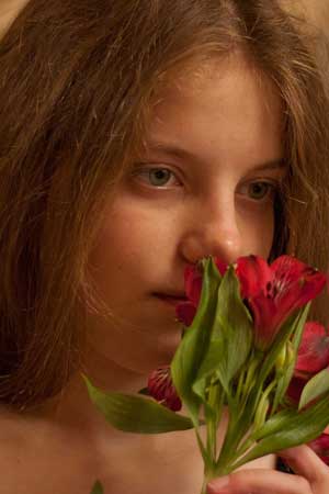 Girl smeling a flower