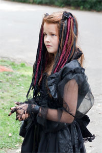 Kid dressed in black victorian dress