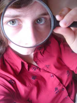 Girl looking through magnifying glass