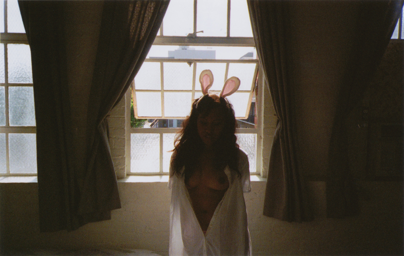 nude woman wearing bunny ears